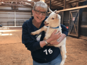 Susan Geiss holding a baby goat