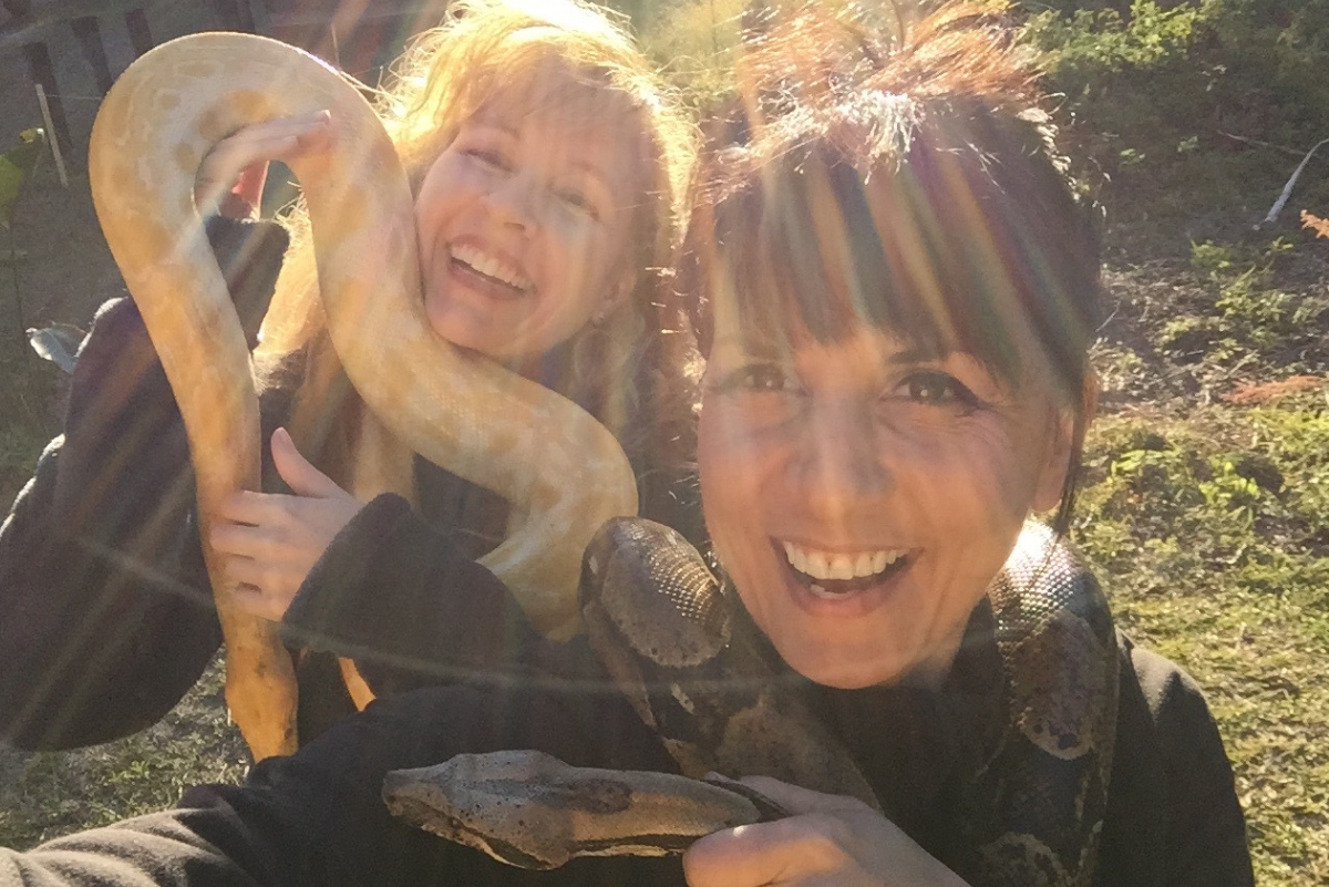 leah d'ambrosio and kathleen prasad holding a blonde python